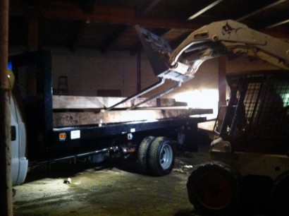 loading reclaimed salvaged antique repurposed heart pine beams from jordan marsh's stable in boston, massachusetts
