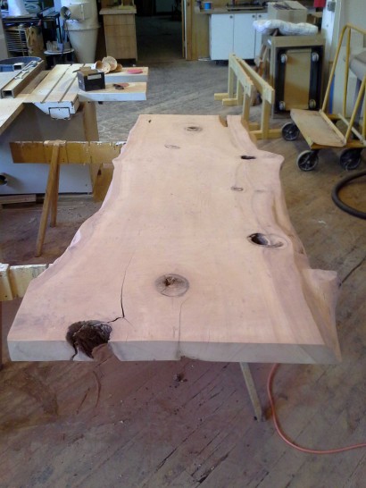 salvaged redwood slab table after a rough sanding
