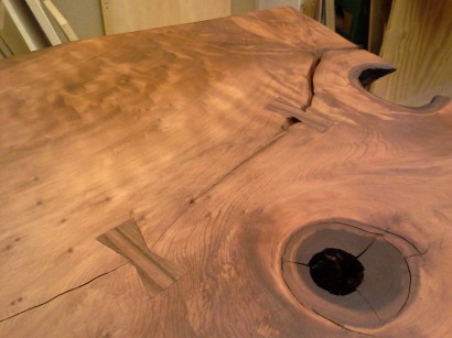 finished redwood slab table with black walnut dutchman patches