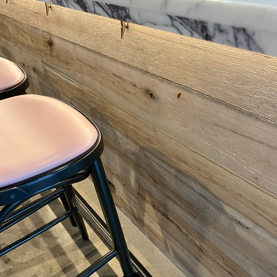Reclaimed maple paneling on restaurant bar front Reclaimed maple paneling on restaurant bar front