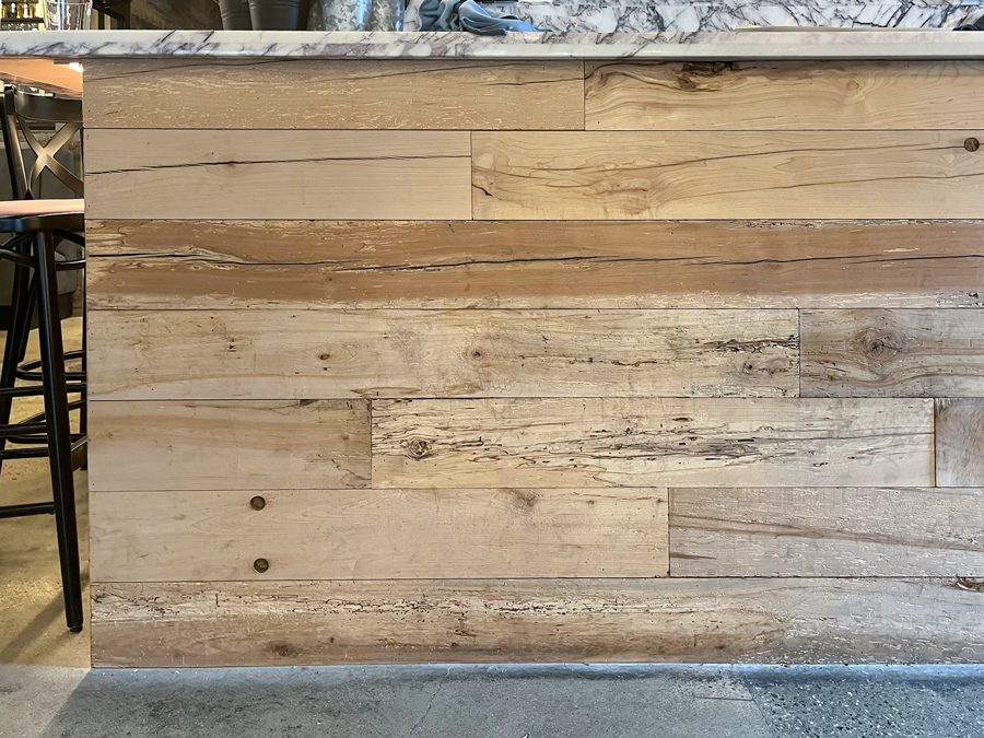 Reclaimed maple paneling on restaurant bar front Reclaimed maple paneling on restaurant bar front