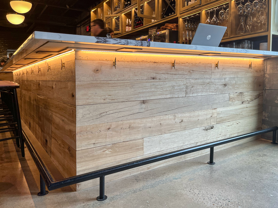 Reclaimed maple paneling on restaurant bar front Reclaimed maple paneling on restaurant bar front